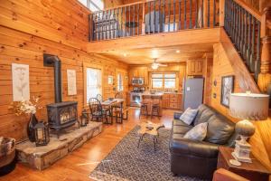a living room with a couch and a stove at West Jefferson Cabin- Hot Tub, Fireplace, Sleeps 7 in West Jefferson
