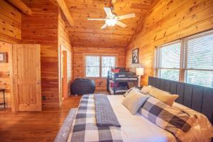 a bedroom with a bed and a ceiling fan at West Jefferson Cabin- Hot Tub, Fireplace, Sleeps 7 in West Jefferson