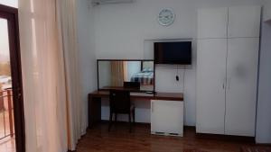 a room with a desk with a computer and a bed at комфорт in Marneuli