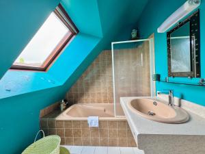 a blue bathroom with a tub and a sink at La Maison Bretonne in Chartres-de-Bretagne +37 photos