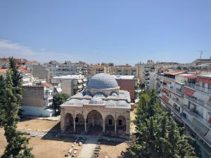 a building with a dome in the middle of a city at Benoikon House With Free Private Parking in Serres