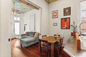 a living room with a table and a couch at Heart of MidCity Front Porch 3bd 2 bath Streetcar in New Orleans