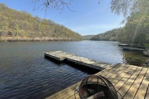 a dock in the middle of a lake at Lake Zoar Cabin in Newtown