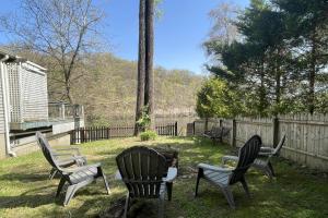 a group of chairs sitting in a yard at Lake Zoar Cabin in Newtown