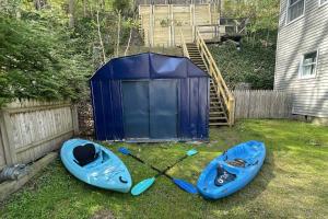 a blue kayak sitting on the grass next to a blue shed at Lake Zoar Cabin in Newtown +42 photos