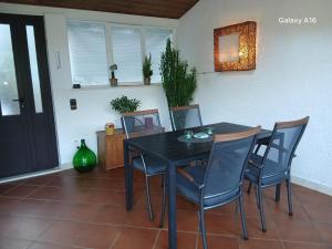 a dining room with a black table and chairs at Apartment Bianca Mljet mit Meerblick in Okuklje +27 photos