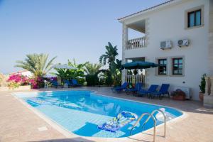 a swimming pool in front of a house at Maria Paradise in Kato Yialia