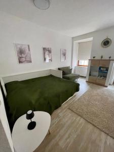 a living room with a green bed and a couch at Bike & Relax in Bernburg