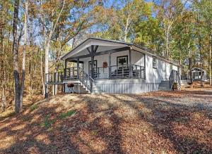 une petite maison au milieu d'une forêt dans l'établissement Broken Bow Cabin with Hot Tub, Deck & BBQ, à Broken Bow