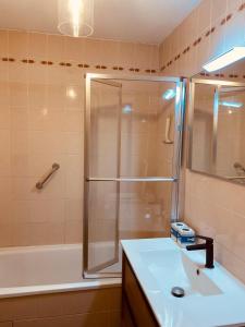 a bathroom with a shower and a sink and a tub at Le Louisiane in Le Touquet-Paris-Plage