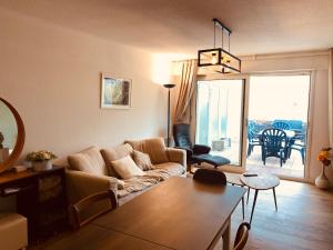 a living room with a couch and a table at Le Louisiane in Le Touquet-Paris-Plage +14 photos