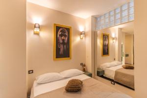 a hotel room with two beds and a mirror at VBM Suite & SPA Apartments in Bari +55 photos