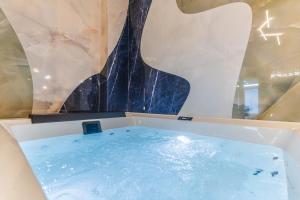 a bath tub with a fountain in a room at VBM Suite & SPA Apartments in Bari