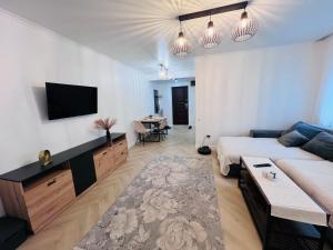 a living room with a couch and a tv at Premium Apartment Turda in Turda