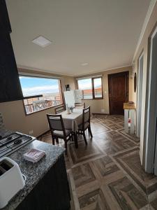 a kitchen and dining room with a table and chairs at CABAÑA M&M in El Calafate +10 photos