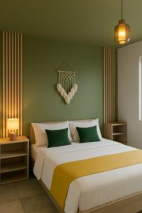 a bedroom with a large bed and a green wall at Gite etape chez Paule et jo in La Possession