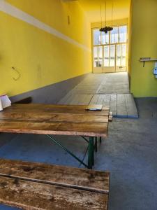 an empty room with a wooden table in front of a door at Privatzimmer 3 in Klingenbach