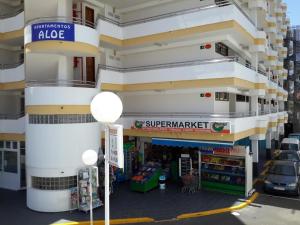 a store front of a building with a supermarket at 6 building Aloe - Free WiFi, Central, near playa dunes in Maspalomas