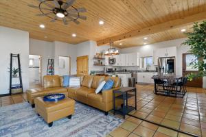 a living room with a couch and a table at New Home, Big Views, Hot Tub, Gazebo! - Casa del Sol in Ranchos de Taos