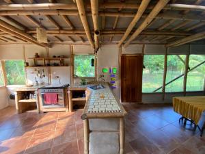a kitchen with a table and a stove in a room at Casa Bambú Veracruz in El Zapote
