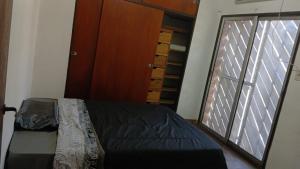 a bedroom with a bed and a large window at La Cascada Country Club in Pilar +30 photos