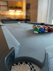 a pool table with balls on top of it at Bright and Cosy Home in Szentendre in Szentendre