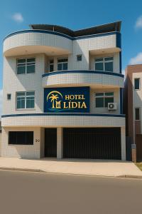 a hotel with a sign on the side of a building at Hotel Lídia in Fortaleza