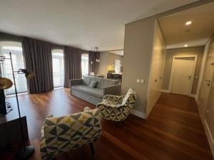 a living room with a couch and chairs in it at New Oporto Apartments - São Bento in Porto