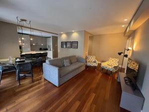 a living room with a couch and a dining room at New Oporto Apartments - São Bento in Porto