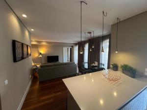 a living room with a couch and a table at New Oporto Apartments - São Bento in Porto +33 photos