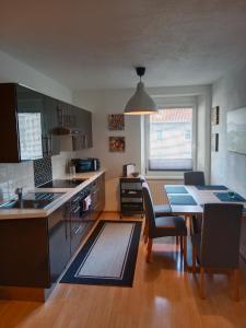a kitchen with a table and a dining room at 2-3 Personen Apartment mit Bergblick in Landeck