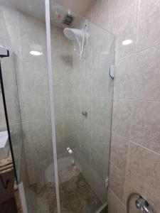 a shower with a glass door in a bathroom at Lindo Studio Largo da Carioca Metrô VLT Lapa in Rio de Janeiro +11 photos