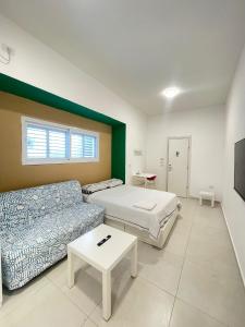 a living room with a bed and a couch at Zan in Netanya