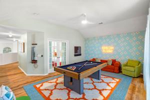 a living room with a pool table in it at Resort Style Backyard Pool Pickleball Court in Lake Dallas