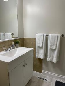 a bathroom with a sink and a mirror and towels at Home beside WEM in Edmonton +32 photos