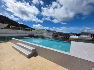 a swimming pool on top of a building at Penthouse 3 bedrooms with sea view and pool - Privilege residence in Patong Beach