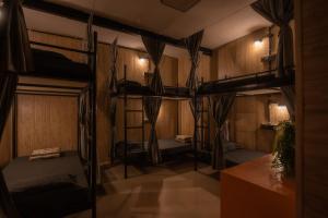a room with four bunk beds in it at Ghumakkads Hostel Near IGI Airport & Aerocity in New Delhi