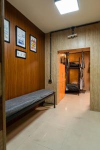 a hallway with a bench in a room at Ghumakkads Hostel Near IGI Airport & Aerocity in New Delhi