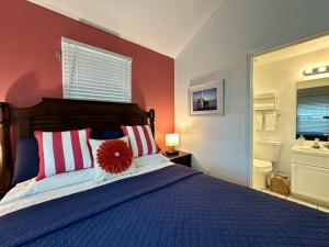 a bedroom with a blue bed with red walls at Seas the Keys Getaway in Duck Key +42 photos