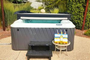 a hot tub with a table with drinks on it at Keppel Cove in Saugatuck