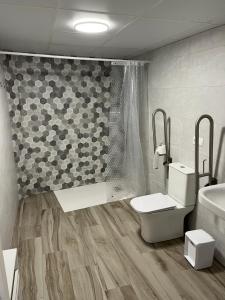 a bathroom with a toilet and a shower and a sink at Apartamentos Rurales El Rincón de la Sierra  +8 photos
