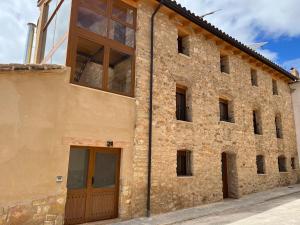 a large brick building with a large window at Apartamentos Rurales El Rincón de la Sierra 