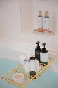 a shelf with toiletries on it in a bathroom at Maison du Voyage New-Elegant villa 3min from Kadena Air Base Gate 3 in Okinawa City +43 photos