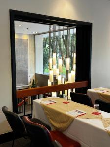 a dining room with tables and chairs and a large window at Cité Hotel in Bogotá +46 photos