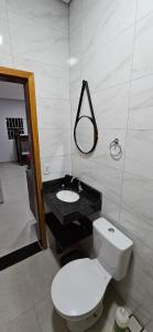 a bathroom with a white toilet and a sink at kitnet 7 Paulista Douglas · Loft 7 Espaço Inteiro Vista para o PQ Ecológico in Indaiatuba