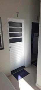 a garage door with a number on it in a room at kitnet 7 Paulista Douglas · Loft 7 Espaço Inteiro Vista para o PQ Ecológico in Indaiatuba +13 photos