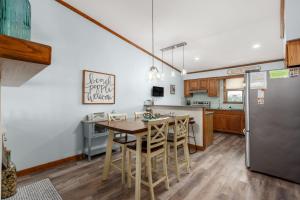 a kitchen with a table and a refrigerator at SDG2 Sea Glass Shack in Kitty Hawk