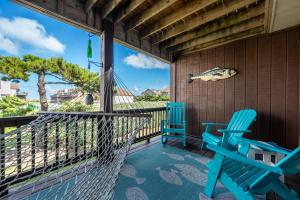 two blue chairs on a porch with a hammock at SDG2 Sea Glass Shack in Kitty Hawk