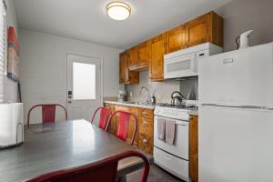 a kitchen with a table and a white refrigerator at Downtown Cozy Home Base - Purple Sage 7 in Moab