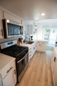 a kitchen with a stove and a sink at Tiny Blanca at Yosemite Gateway in Groveland